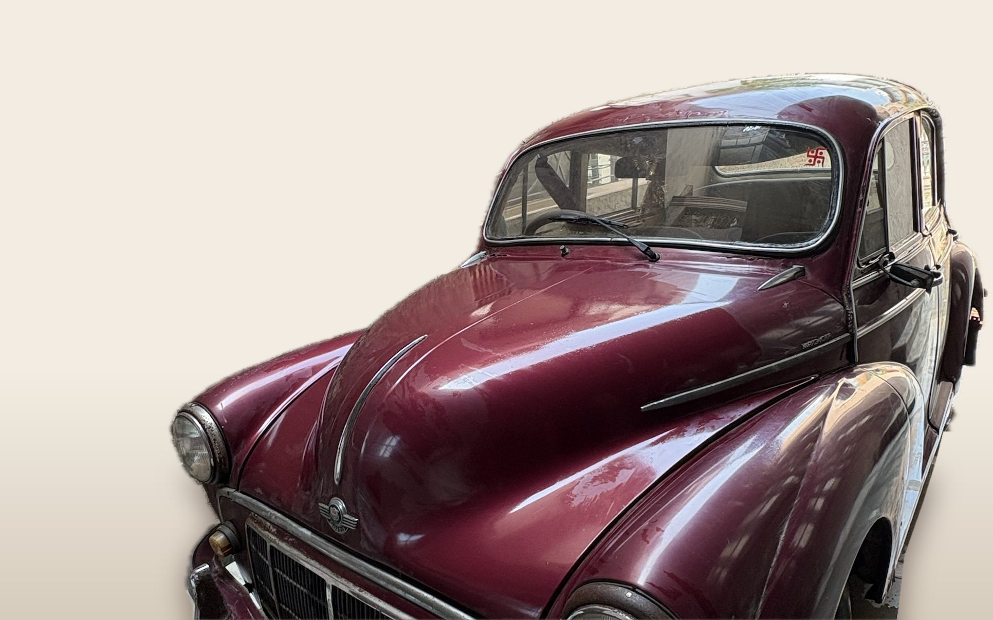 Maroon Morris Minor 1000 four-door saloon for sale in Gurgaon, photographed from the front three-quarter angle