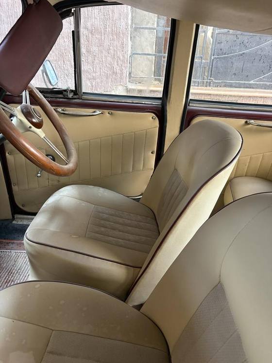 Cream leatherette seats with maroon piping
