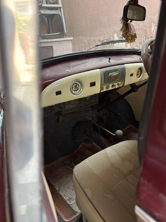 Cabin through the open door: dash, gear lever, floor